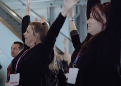 reaching high ergonomic group stretch break at health conference